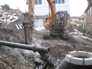 Mikula employee using excavator for commercial drainage job
