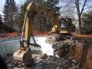 Mikula excavator digging at pool removal job