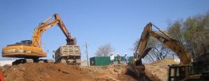 Two excavators digging at construction job site