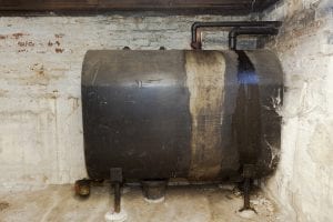Old heating oil tank in dingy dank basement.