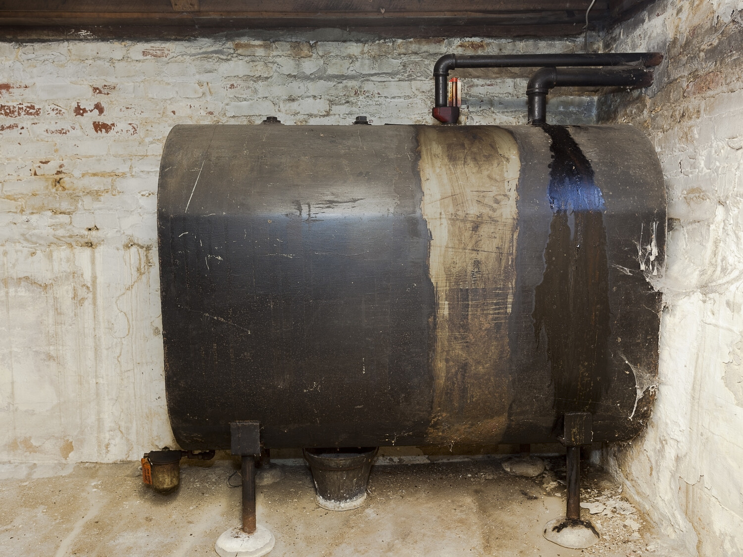 Old heating oil tank in dingy dank basement.