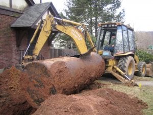 Excavation machine performing residential oil tank removal