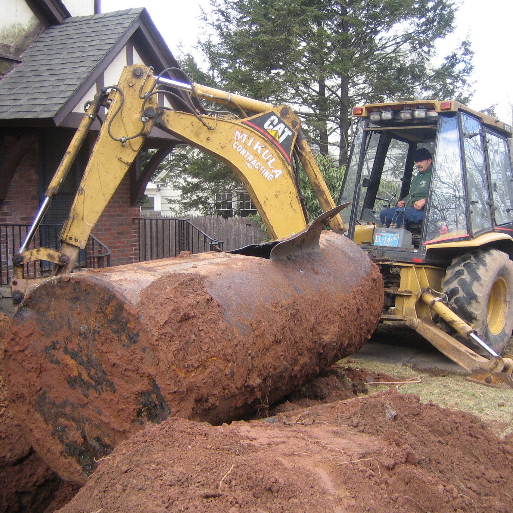 Excavation machine performing residential oil tank removal
