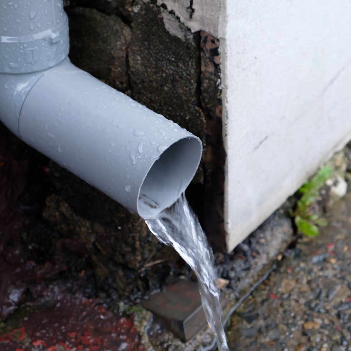 water spout directing yard drainage residential property mikula contracting