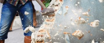 construction worker using mallet to perform demolition job