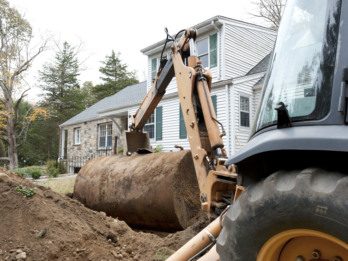 Old oil tank in front of house being removed