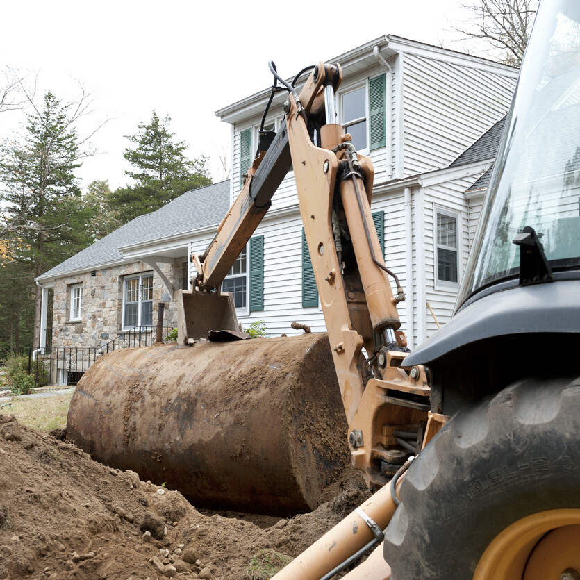Old oil tank in front of house being removed