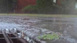 storm water on street flooding into water grate