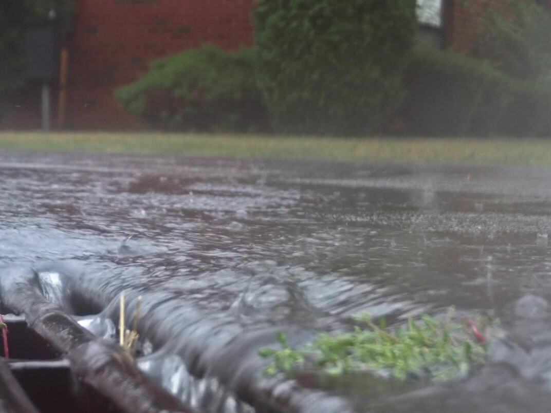 storm water on street flooding into water grate