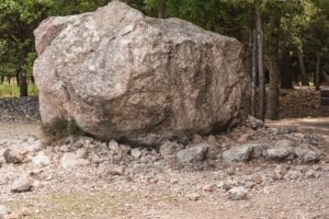 Large boulder with rocks in the woods