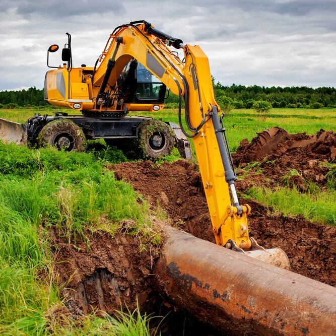 Yellow Construction Excavator performing Commercial Excavation Job