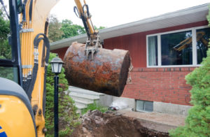An underground oil tank is dug up and removed by a contracting company.