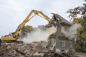 excavator demolishing a home