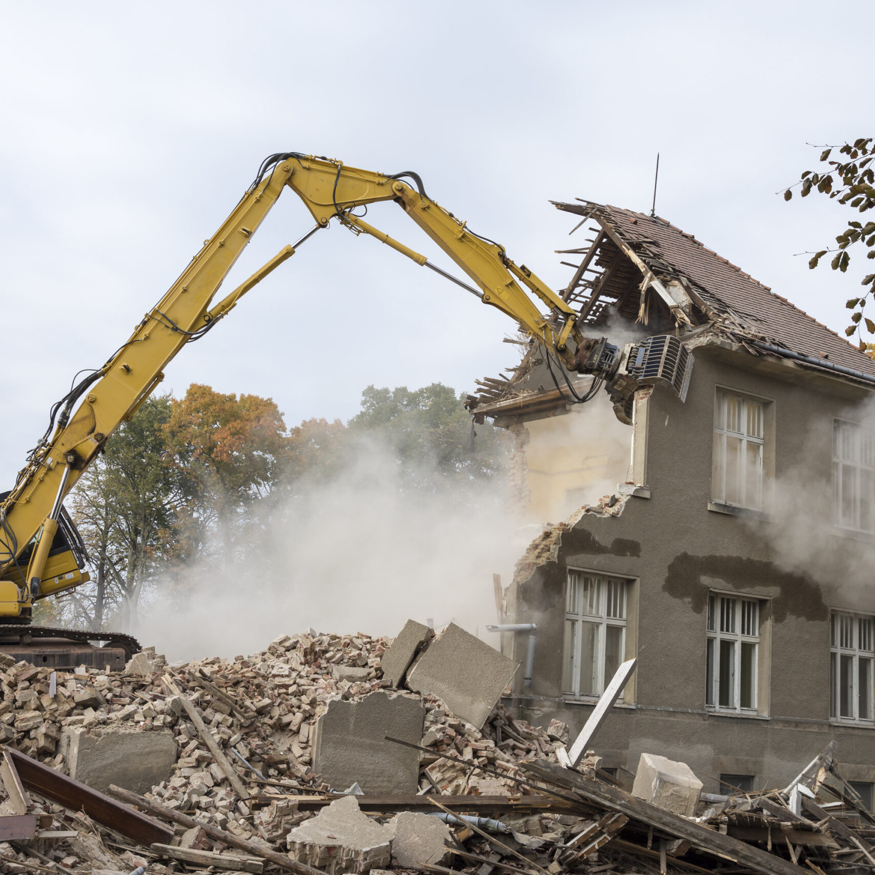 excavator demolishing a home
