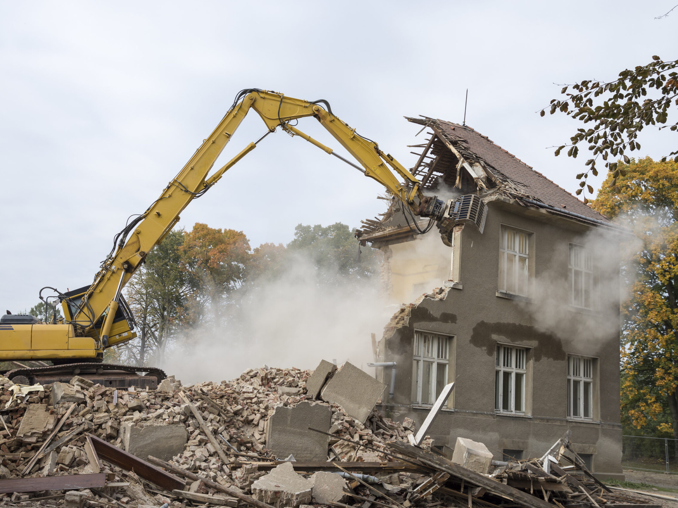 excavator demolishing a home