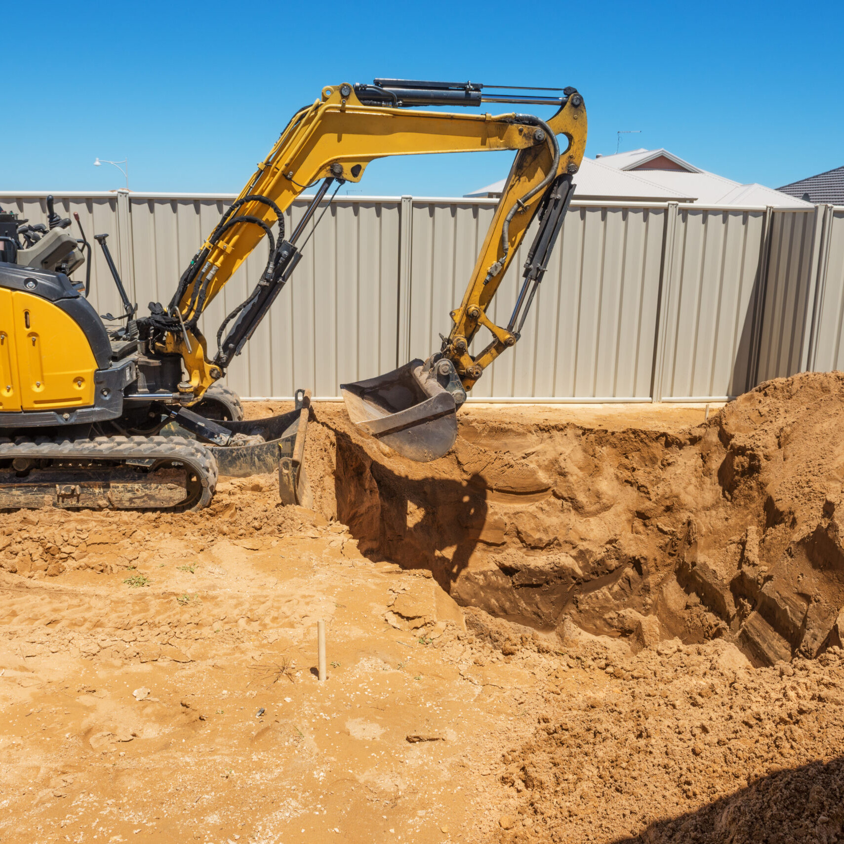 excavator breaking ground at a construction site
