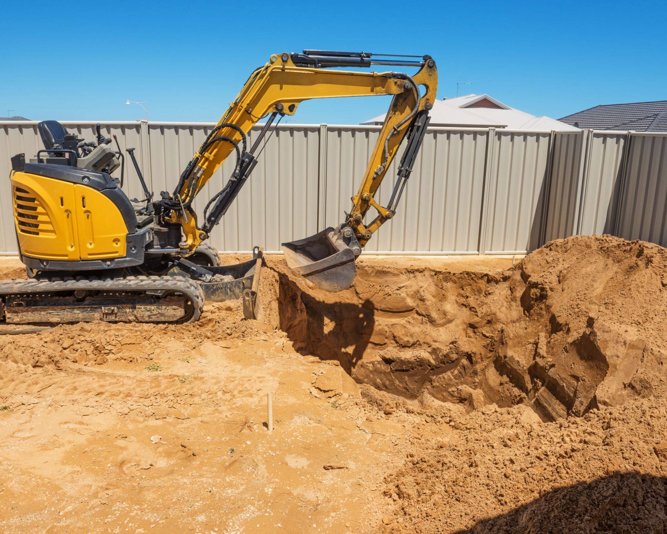 excavator breaking ground at a construction site