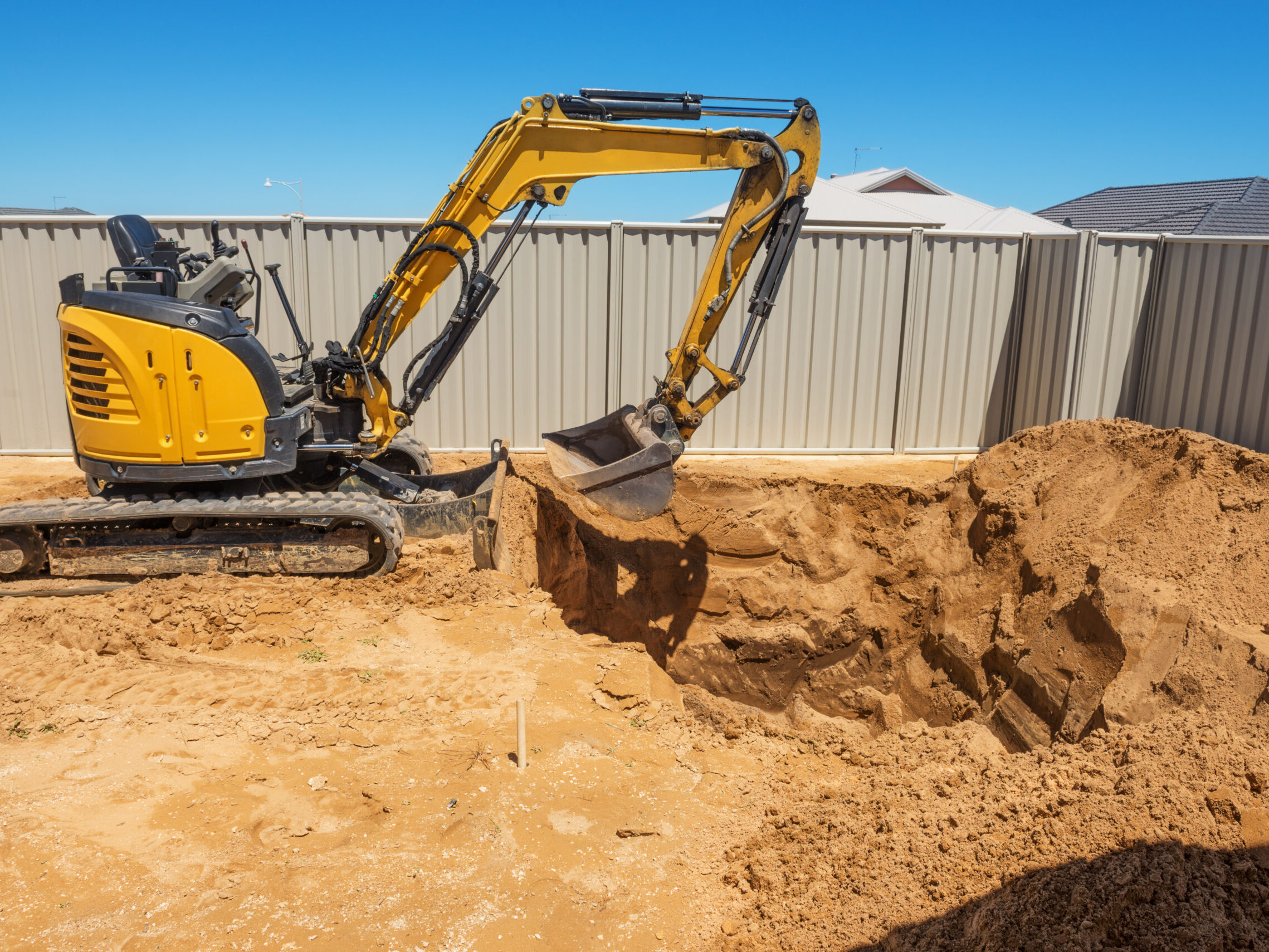 excavator breaking ground at a construction site