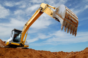 An Excavator Digging Into A Construction Site