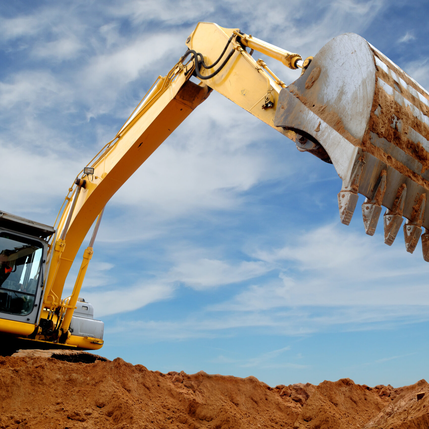 An Excavator Digging Into A Construction Site