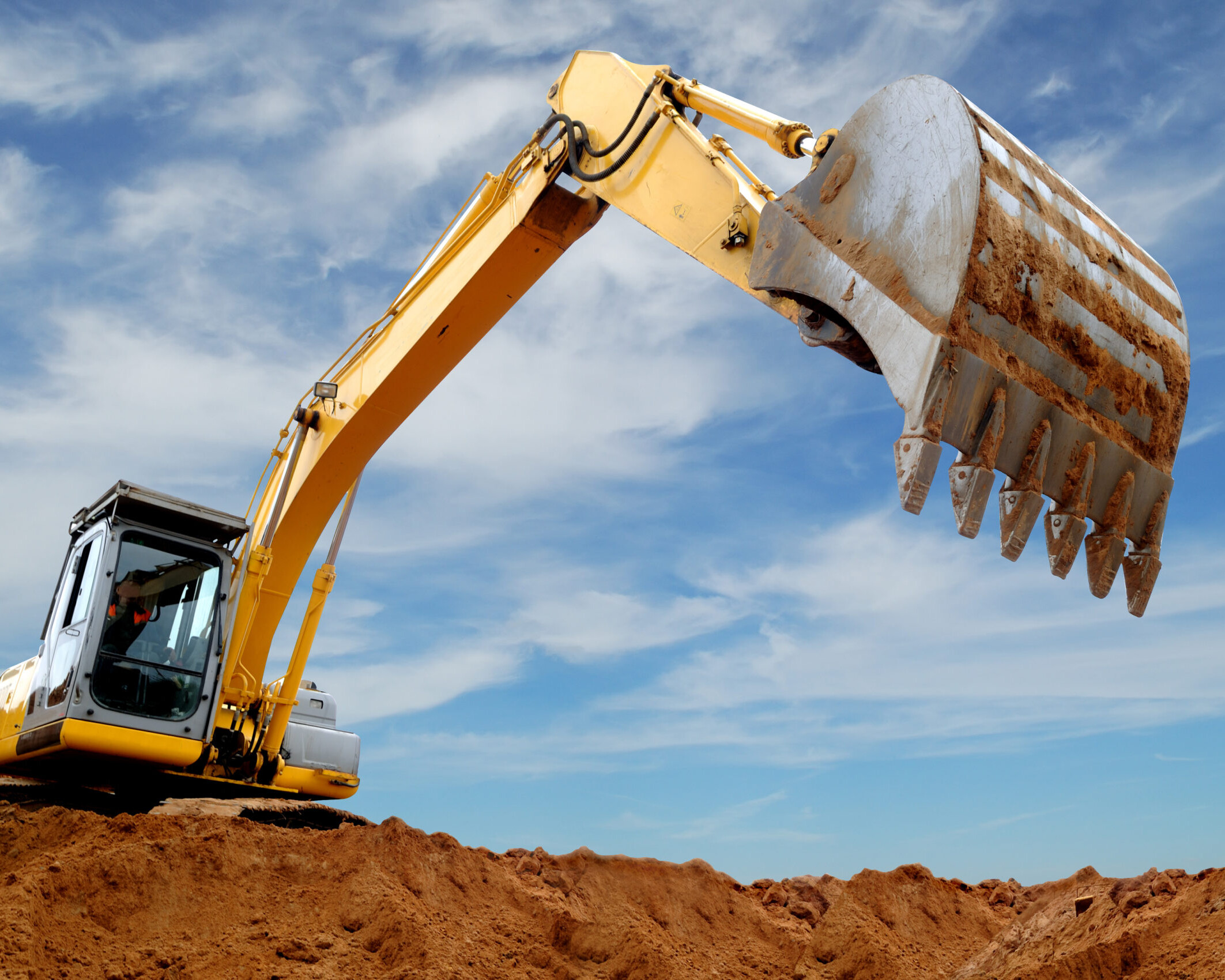 An Excavator Digging Into A Construction Site