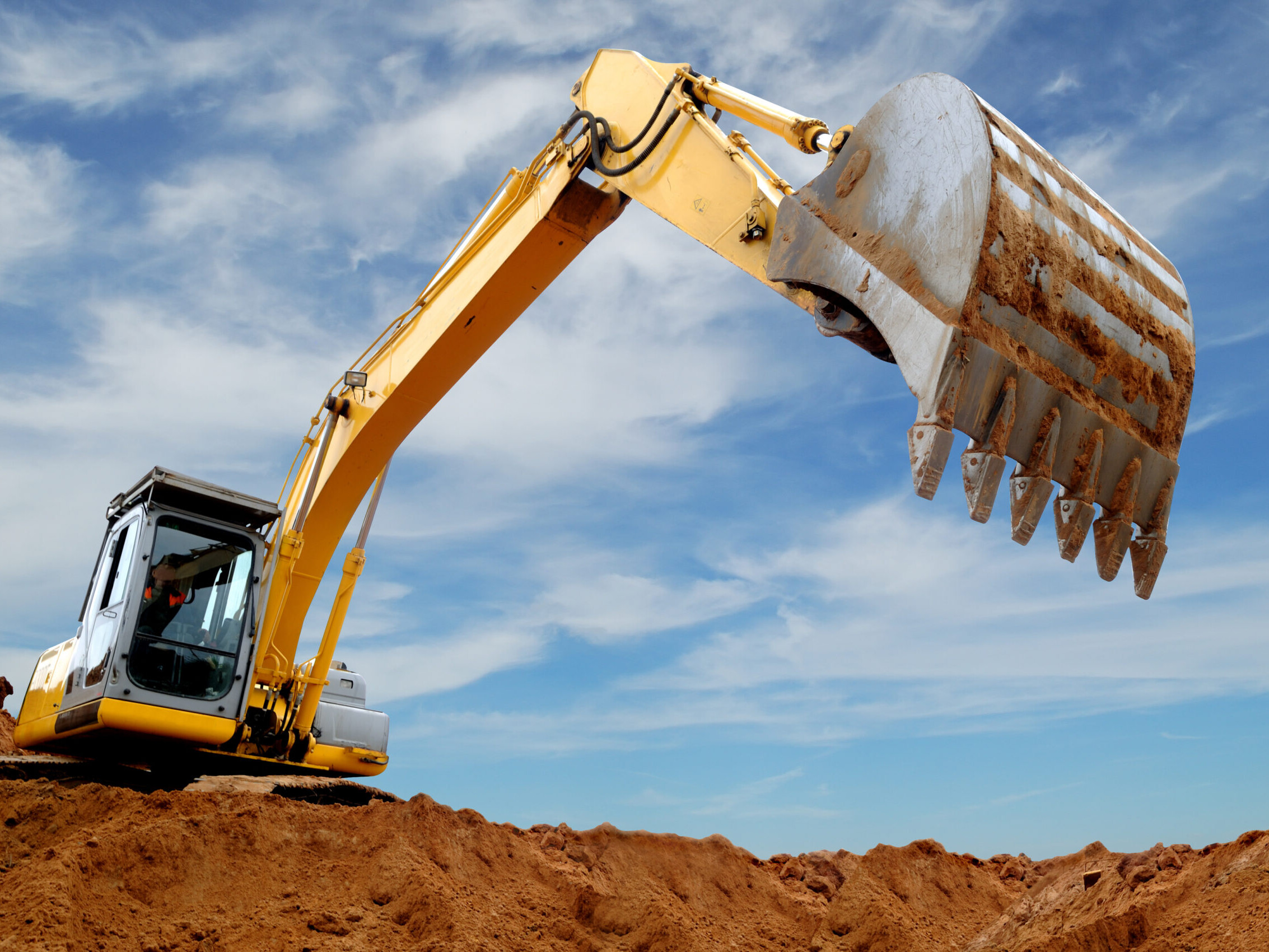 An Excavator Digging Into A Construction Site