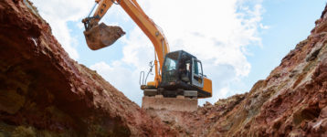 Excavator Digging Into A Construction Site
