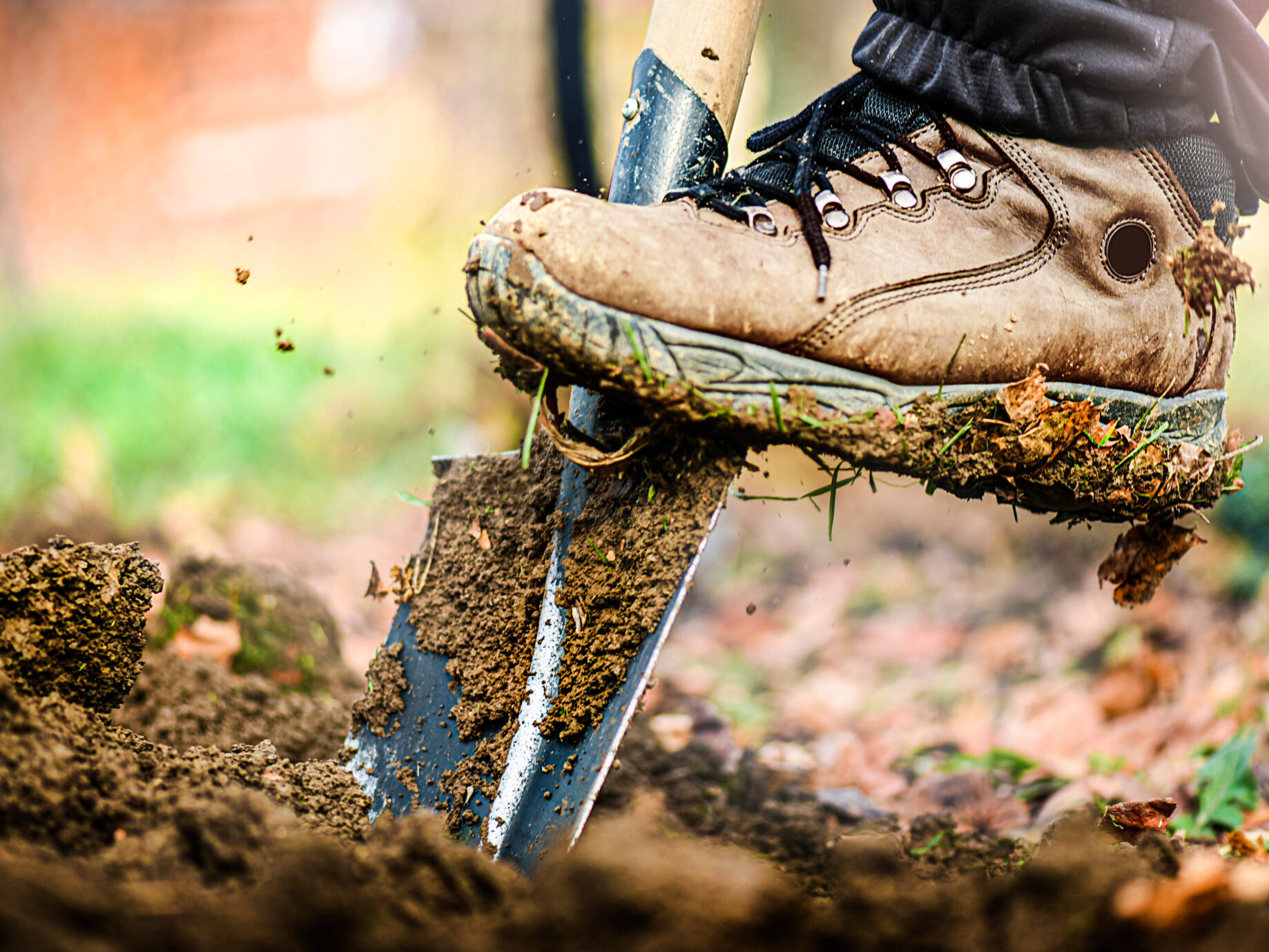 picture of a shovel breaking ground while digging a foundation