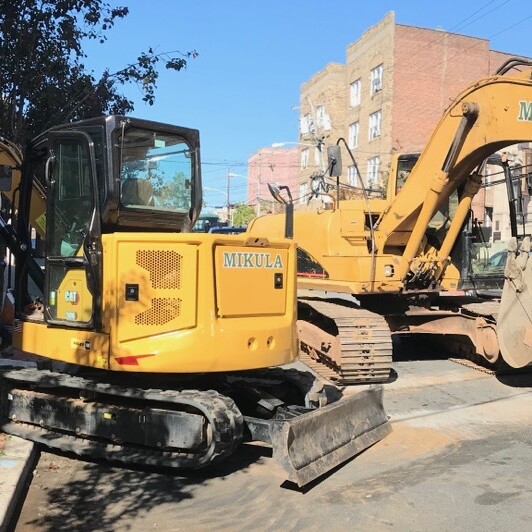 excavator in the middle of the street