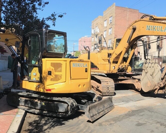 excavator in the middle of the street