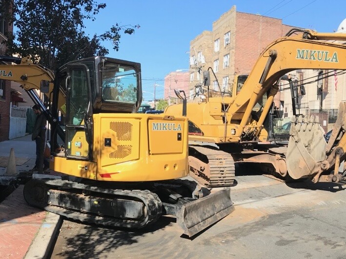 excavator in the middle of the street