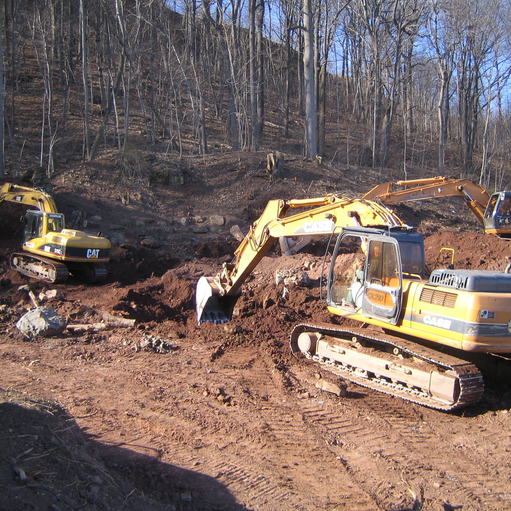 Contractor clearing land with an excavator.