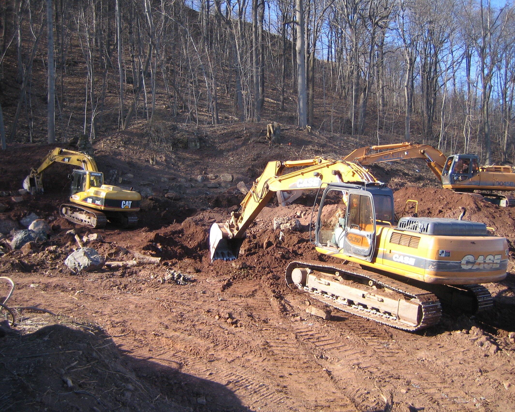 Contractor clearing land with an excavator.