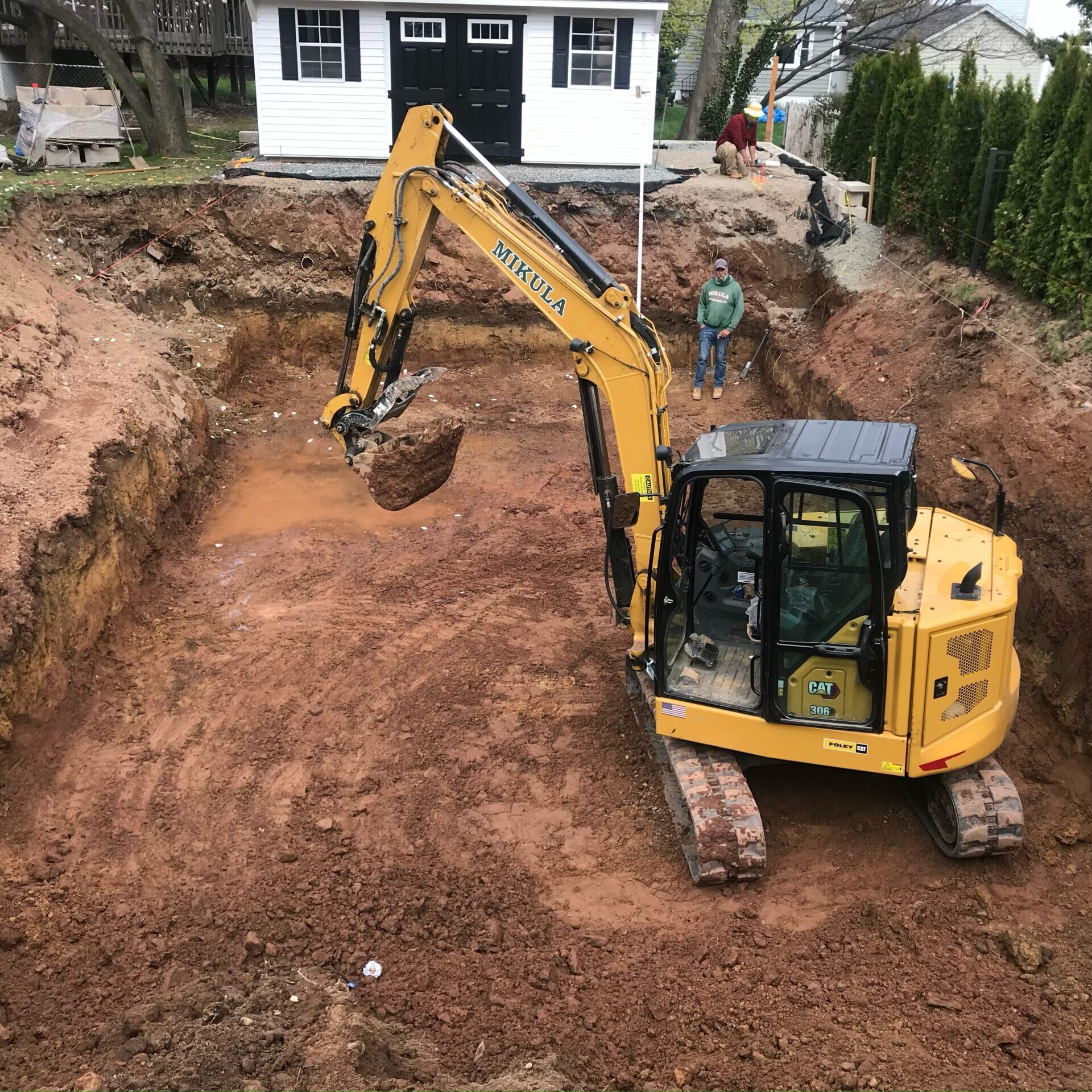 excavator working in someone's yard