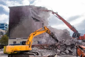 Demolition of buildings in urban environments with heavy machinery