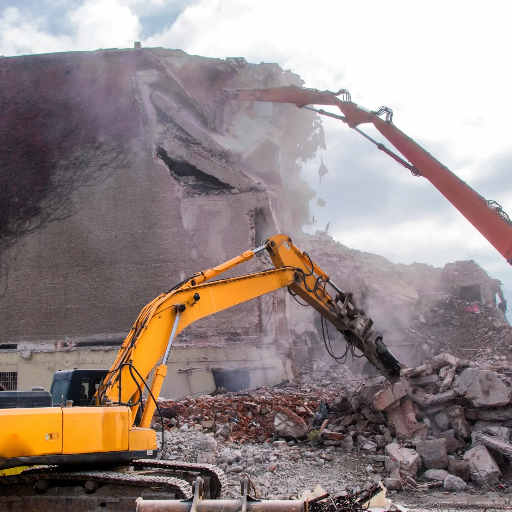 Demolition of buildings in urban environments with heavy machinery