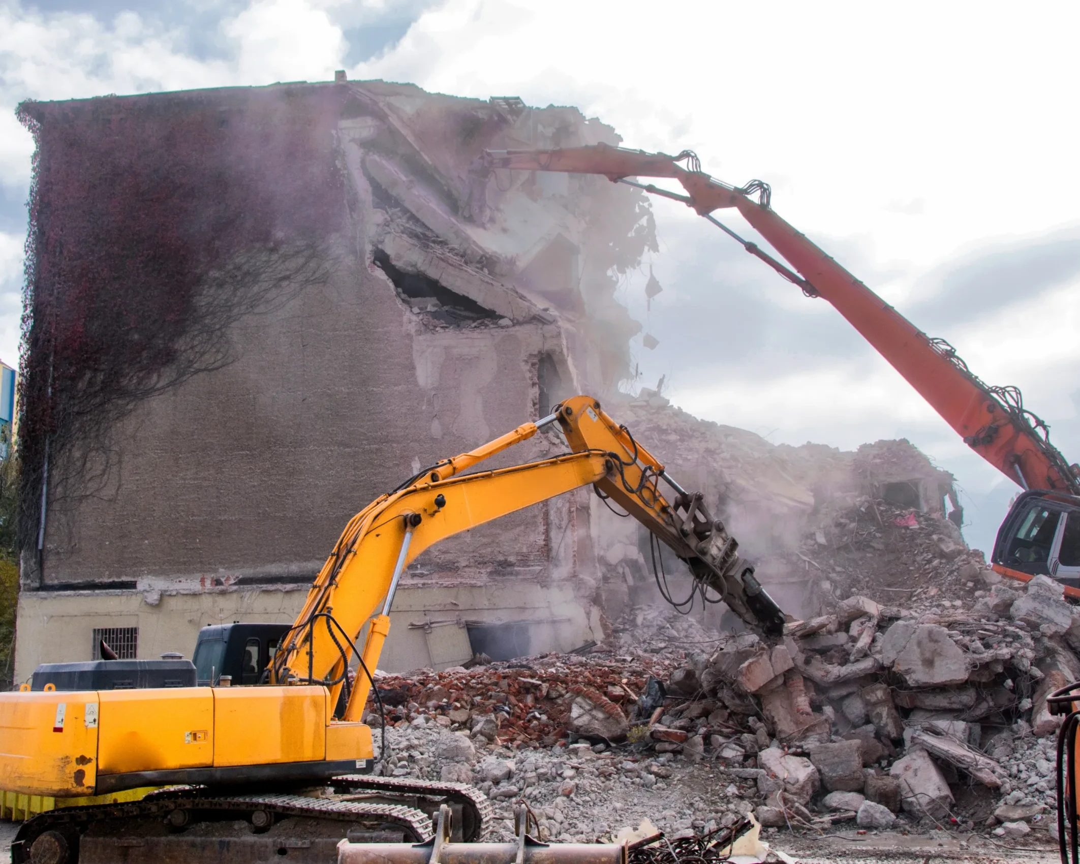 Demolition of buildings in urban environments with heavy machinery