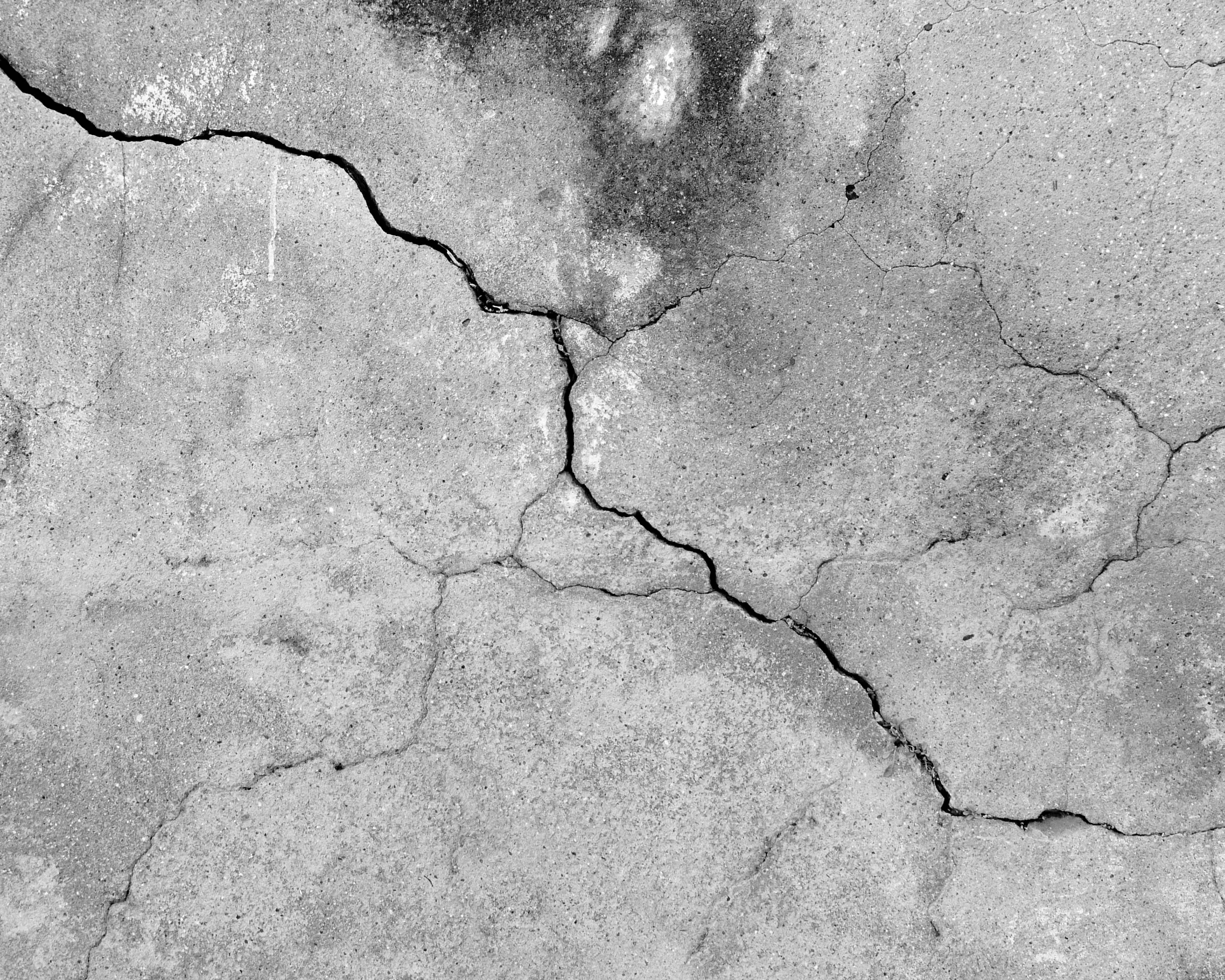 Grunge concrete cement wall with crack in industrial building