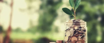 concept growth money and tree on coin glass jar saving and investment