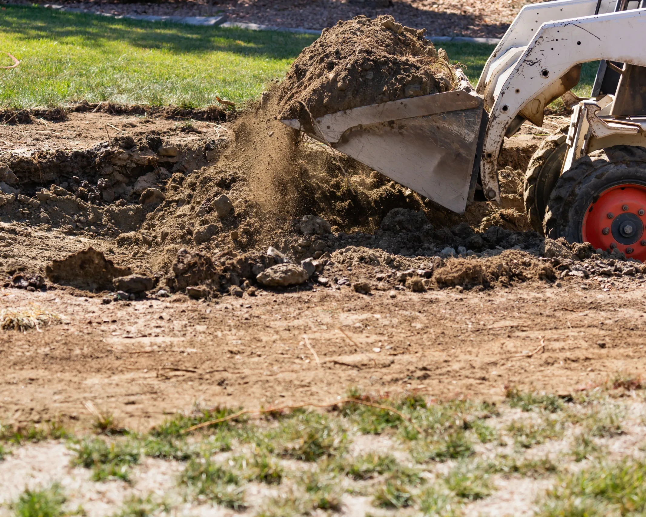 Small Bulldozer grading a yard for drainage