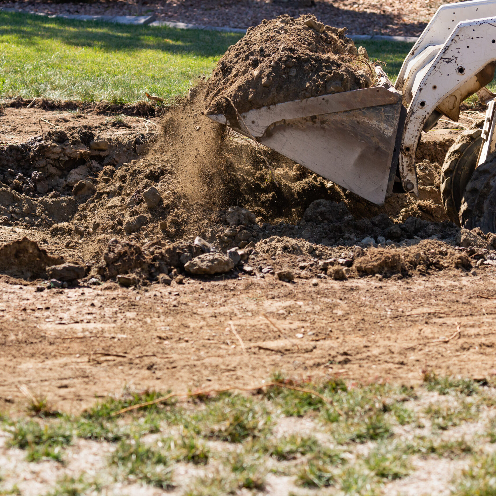 Small Bulldozer Digging In Yard For Pool Installation